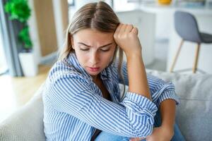 Close up young woman feeling upset, sad, unhappy or disappoint crying lonely at home. Emotional shock and life problems photo