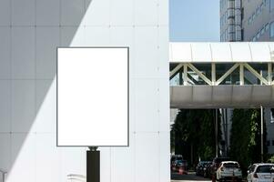 Outdoor pole vertical billboard with mock up white screen. Clipping path for mockup photo