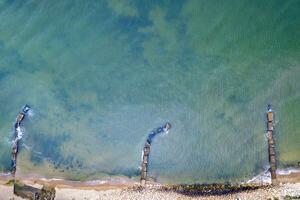 Aerial top view from drone to the seacoast and old concrete piers. Sea background. photo