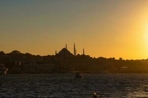 Istanbul photo. Silhouette of Suleymaniye Mosque at sunset. photo