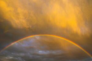 Rainbow and clouds at sunset photo