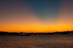 Istanbul skyline with crepuscular rays at sunset. photo