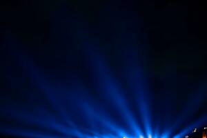 Blue spotlight rays. Projector light rays background photo