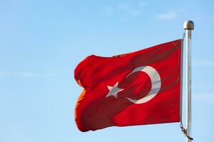 Turkish Flag isolated on blue sky background photo