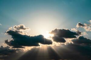 Silhouette of the clouds and sunrays at sunset. photo