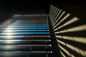 Office or window blinds or jalousies with shadows on the wall. photo