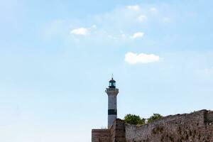 Lighthouse at daytime with partly cloudy sky. Ahirkapi lighthouse in Istanbul photo