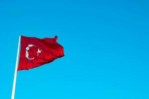Turkish Flag isolated on blue sky background with copy space for text. photo