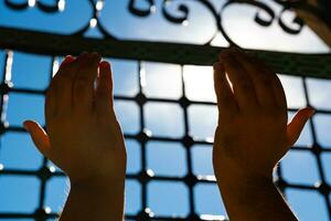 Islamic photo. Muslim man praying with raising his hands. Ramadan concept photo