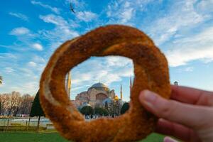 Travel to Istanbul concept photo. Hagia Sophia and Turkish Bagel aka Simit photo