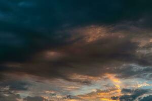 Dramatic or cinematic clouds at sunrise. Morning cloudscape. photo