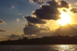 Silhouette of the historical peninsula of Istanbul with dramatic sky at sunset photo
