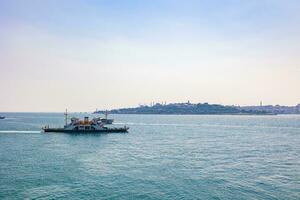 Istanbul view with a ferry boat from Maiden's Tower photo