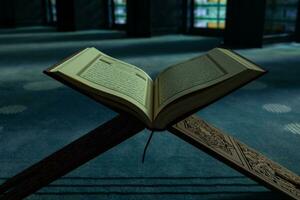 Islamic or ramadan kareem or eid mubarak concept. The Holy Quran in a mosque photo