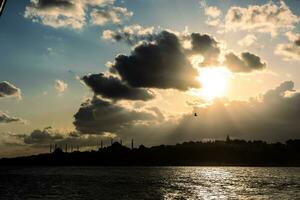 Istanbul skyline at sunset. Silhouette of the Historical Peninsula of Istanbul photo