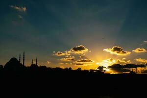 Silhouette of Istanbul at sunset and crepuscular rays. Islamic concept photo