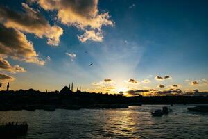 Istanbul at sunset. Silhouette of cityscape of Istanbul with partly cloudy sky photo