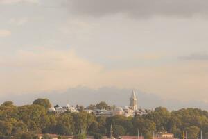 Topkapi Palace and Gulhane Park from Karakoy district at sunset. photo