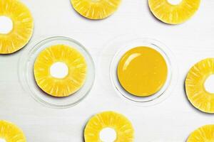 Pineapple Lime Slices. Serum and Pineapple pieces on a white background, beauty. photo