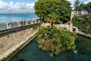 Syracuse, Italy-May 9, 2022-View of the Fonte Aretusa in the island of Ortigia in Syracuse during a sunny day photo
