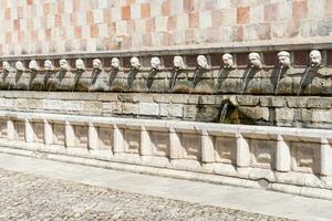 L'Aquila, Italy-august 11, 2021-Particular of the Fountain of 99 Spouts during a sunny day photo