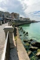 Syracuse, Italy-May 9, 2022-View of the famous pedestrian route located on the Alfeo seafront in Syracuse during a sunny day photo