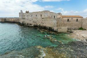 Syracuse, Italy-May 9, 2022-view of the famous Maniace Castle on the island of Ortigia in Syracuse during a sunny day photo