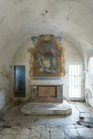 L'Aquila, Italy-august 12, 2021-ruins of the Hermitage of the Holy Spirit an ancient church dug into a cliff with a well-preserved fresco, altar and hermit's cells. photo