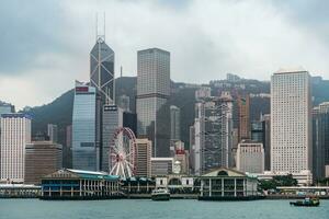 Hong Kong,March 27, 2019-View of the Hong Kong skyscrapers from the ferrie crossing the Victoria Harbour during a cloudy day photo