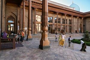 Tashkent, Uzbekistan-august 11, 2023-people in the courtyard of the Khazrati Imam Mosque in the Hazrati Imam complex during a sunny day. photo