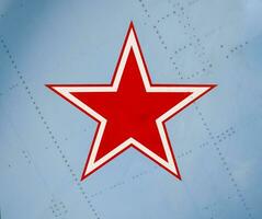 Five-pointed red star on the wing skin of a military fighter photo