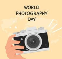 World photography day greeting card. Square banner with a hand holding digital camera in retro look. Background with world map. Vector illustration in flat cartoon style.