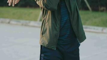 Attractive young man stretching in the park before running at the sunset focus on shoes video