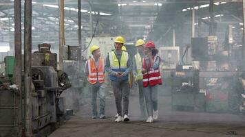 grupo de diversidad fábrica trabajador personas inspeccionando y comprobación local depósito, asiático, blanco caucásico y asiático personas en pesado máquina a industria fábrica. concepto ingeniero operando y control. video