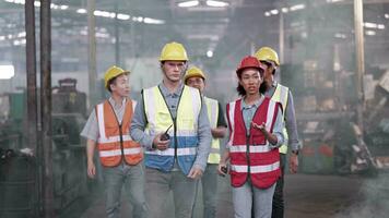 Group of Diversity factory worker people inspecting and checking  local warehouse, asian, white caucasian and asian people in heavy machine at industry factory. Concept Engineer Operating and control. video
