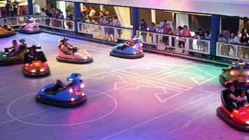 Electric bumper cars or dodge cars at onboard Royal Caribbean Cruise ship spectrum of the seas in night carnival theme. Bumper car at cruise ship. video