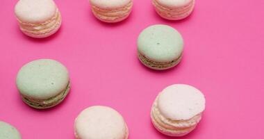 Multiple sweet colored macaroons on pink background video