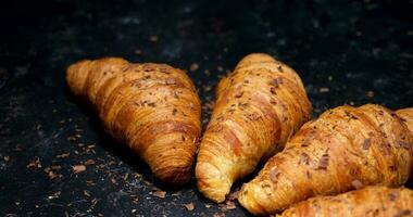 Chocolate croissants with chocolate crumbs on top. Panning from above on beautiful croissants video