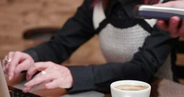 Close up shot of woman paying for coffee with her smartphone using NFC payments. Financial technology video