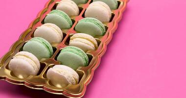 Close up on sweet macaroons on pink background. Delicious desserts video