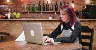 Waiter brings coffee and croissant to businesswoman who works in a vintage coffee shop or pub video