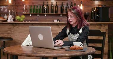 Zoom in shot on woman in coffee shop paying with her smartphone to a waiter video