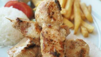 Chicken skewers with french fries and rice video