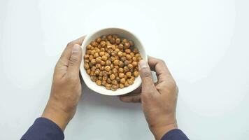 hand pick Roasted yellow chickpeas in bowl . video