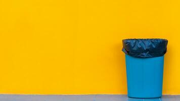 Garbage bin on yellow background, Ecological concept Reduce, reuse, recycle, ecological metaphor for ecological waste management and sustainable and economical lifestyle. photo