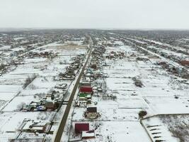 Winter view from the bird's eye view of the village. The streets are covered with snow photo