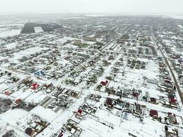 Winter view from the bird's eye view of the village. The streets are covered with snow photo