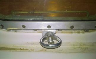 The fastening element is the lock on the porthole window. A window in the ship photo