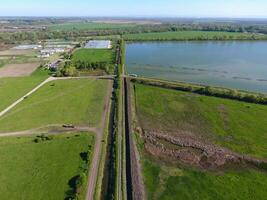 Rural landscape. View from above. On the horizon there is a fish hatchery, a field, forest belts and a river. Roads in the fields. photo
