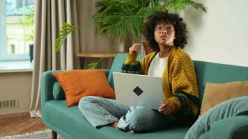 African American girl using laptop at home office looking at screen typing chatting reading writing email. Young woman having virtual meeting online chat video call conference. Work learning from home